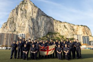 Group photograph of all attendees by the Rock.