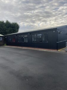 External view of building once works completed. Looking clean and new with a black exterior.