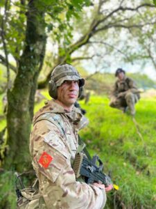 Lt Newport Cater in the field, wearing camouflage.