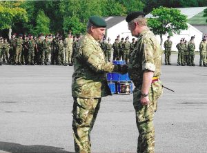 Commandant handover in 2013 - two people shaking hands.