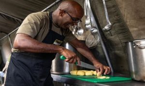 Private Francis cooking in a field kitchen.