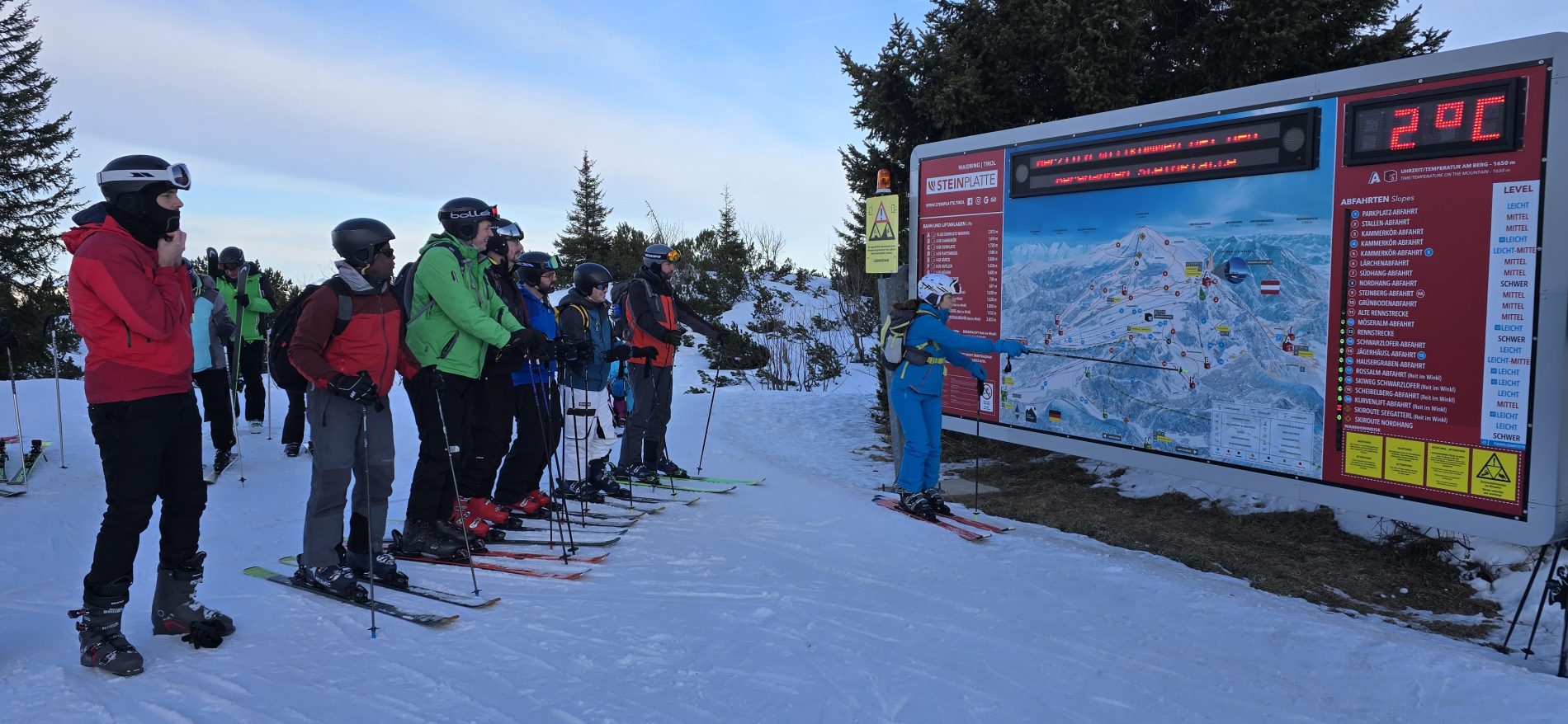 SF1 selecting their first run of the morning. On skis looking at the map of ski runs and which are open.