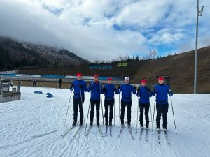 Team photograph on skis on the snowy mountain.