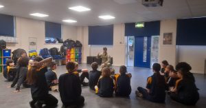 A cadet speaking to a classroom of students.